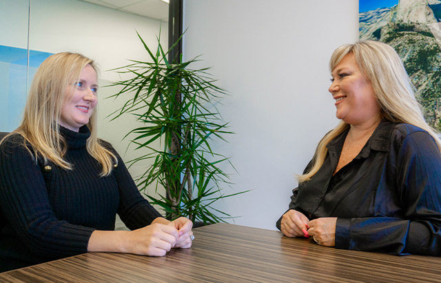 Malinda Goller and a personal banking client in a meeting