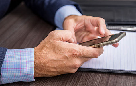Tom Calahan replying to a client on his cell phone