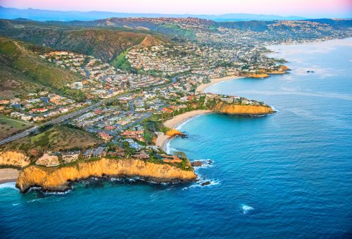 Wide angle aerial view of the homes along the beautiful coastal cliffs of Laguna Beach, California.