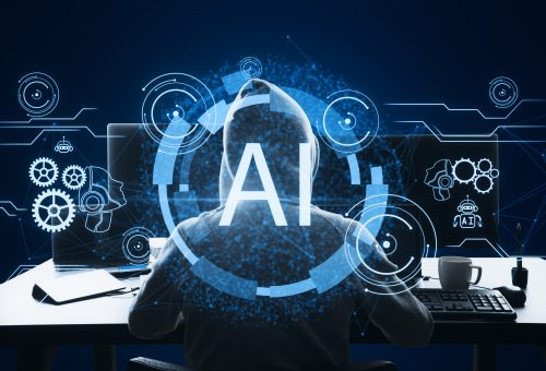 Back view of hacker using computers at desk with glowing AI hologram on blue background. Artificial intelligence, hacking, malware, robotics and chat gpt concept.
